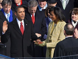 Barack Obama, left, joined by his wife Michelle, second from left, and daughters Sasha, third from left, and Malia, takes the oath of office from Chief Justice John Roberts to become the 44th president of the United States at the U.S. Capitol in Washington, DC.